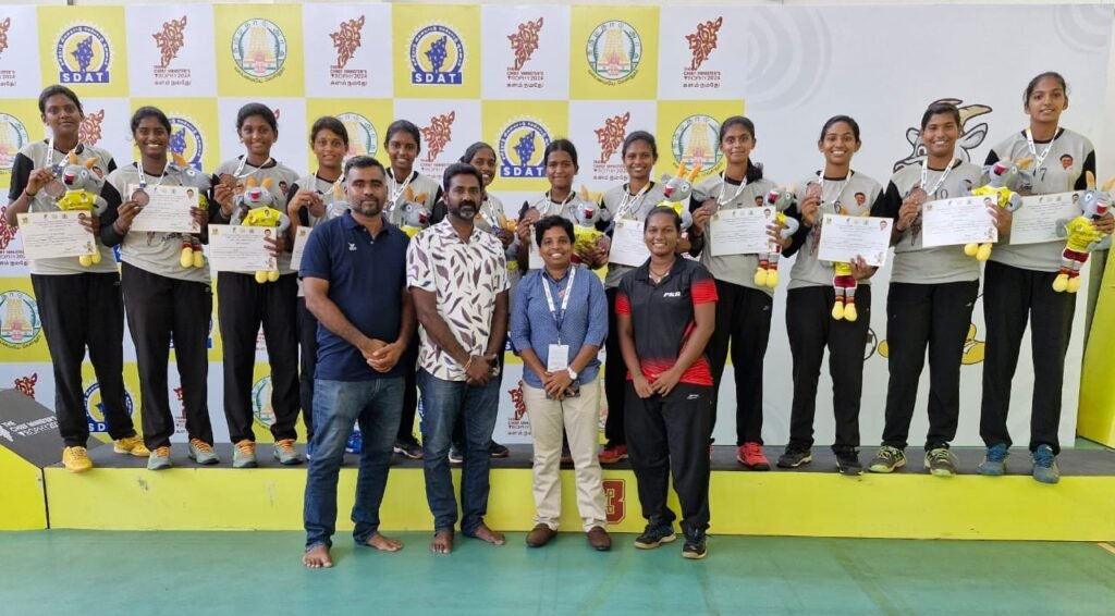 “PKR Arts College for Women Volleyball Team celebrating their Bronze medal win at the Chief Minister’s Trophy 2024–2025 with coaches and awards